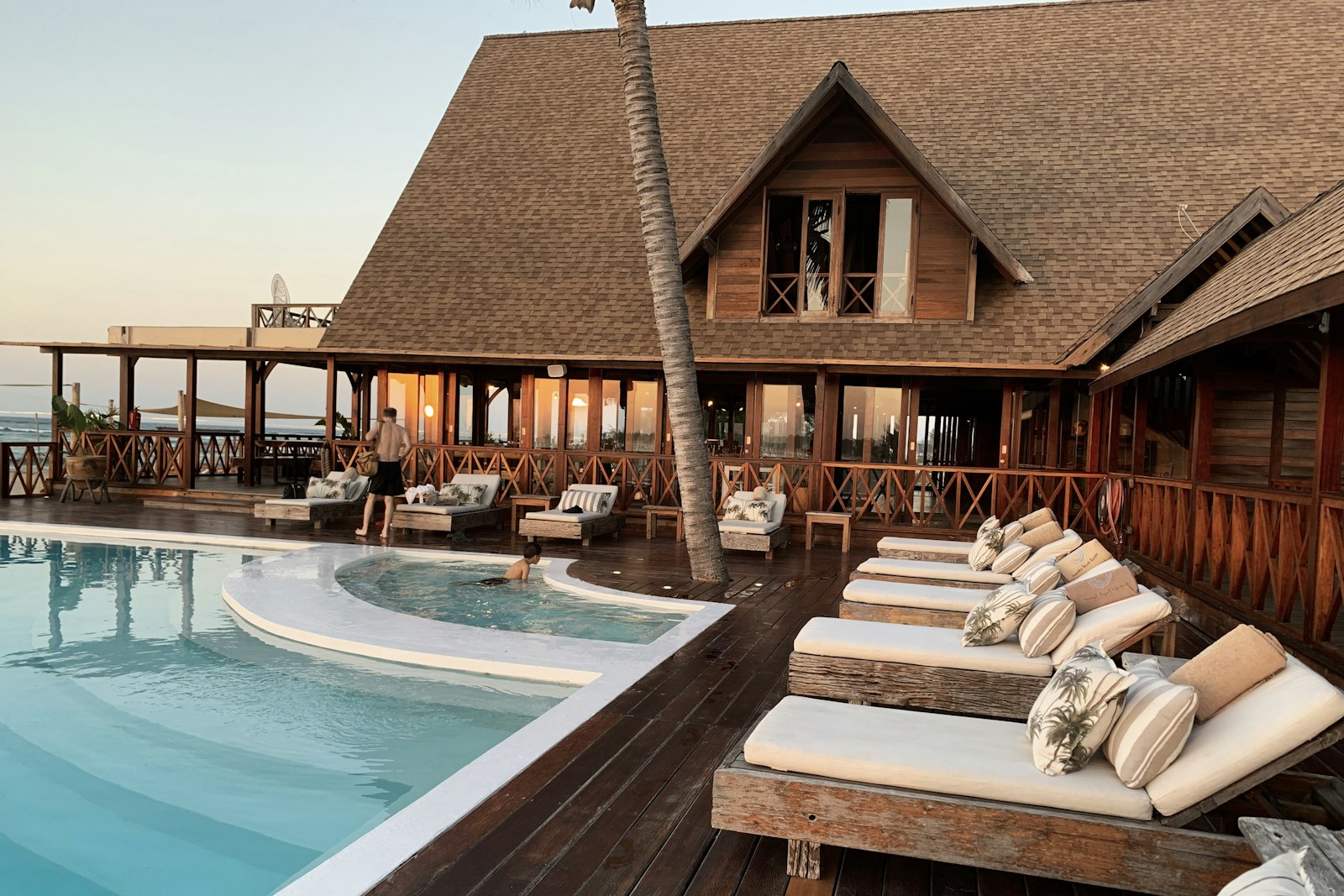 A tranquil resort pool surrounded by palms